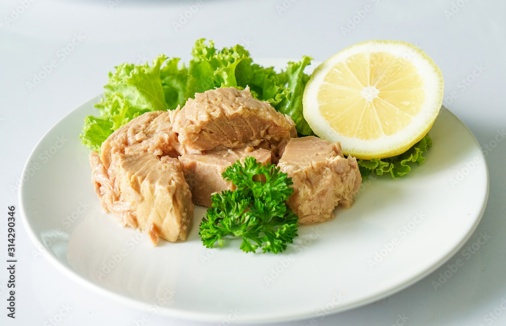 Tuna chunk on white plate. Tuna chunk on white plate.