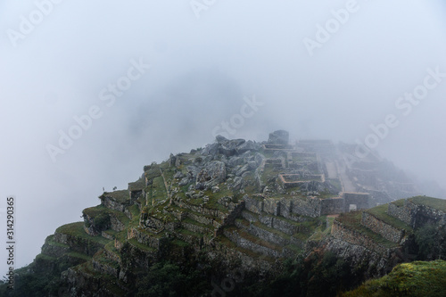 view from the top of mountain on a cloudy day . Inca ruins 