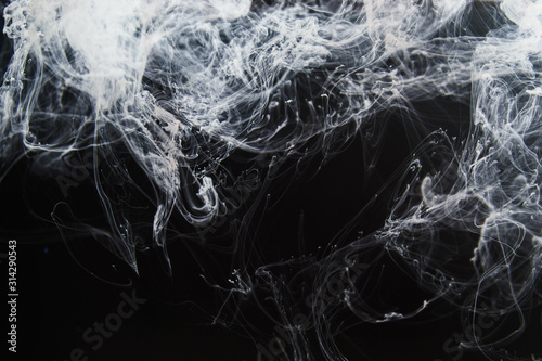 Abstract background with fine structure of white fume smoke traces on black background.