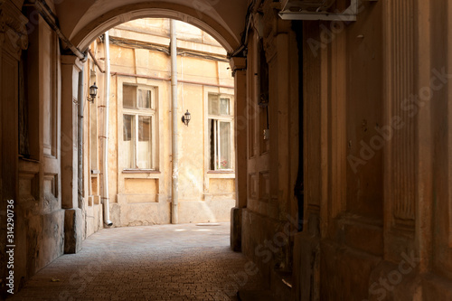 Passage through the arch to typical courtyard of the old historic building in Odessa city center  Ukraine