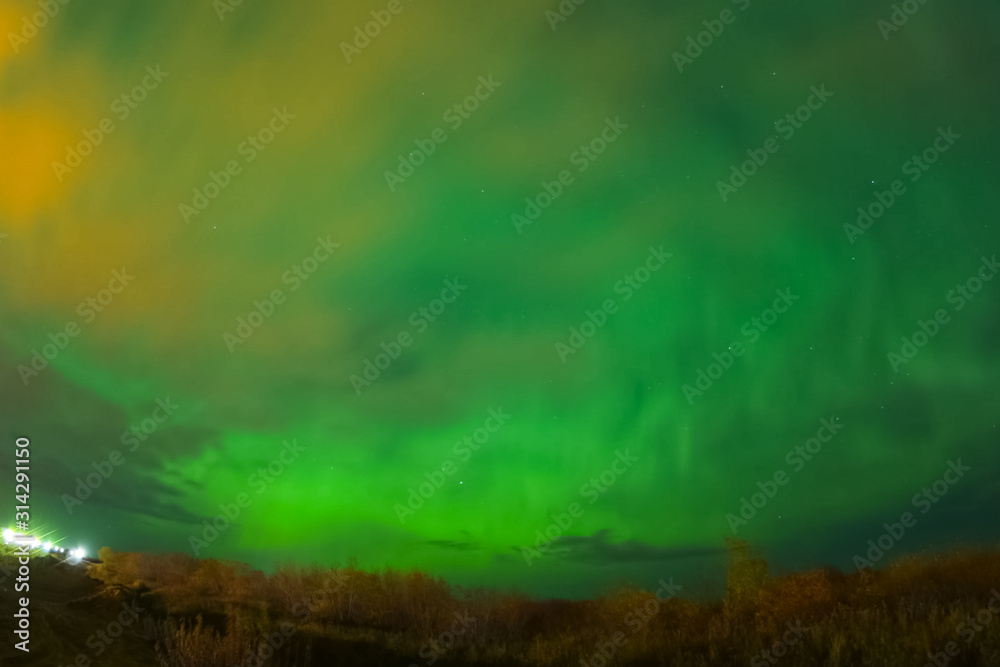 Aurora borealis in night northern sky. Ionization of air particl Aurora borealis in night northern sky. Ionization of air particl