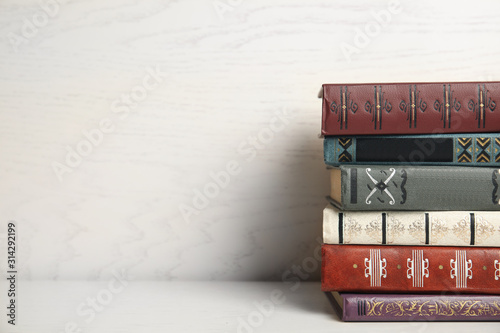 Collection of different books on table against white wooden background. Space for text