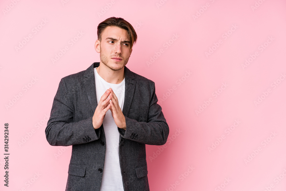 Young caucasian business man posing isolated making up plan in mind, setting up an idea. Young caucasian business man posing isolated making up plan in mind, setting up an idea.