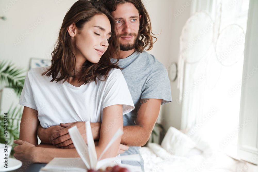 Couple indoors at home posing hugging. Couple indoors at home posing hugging.