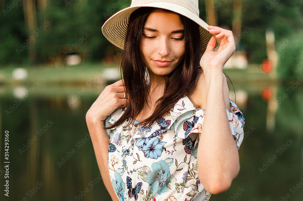 Young beautiful woman posing near lake.