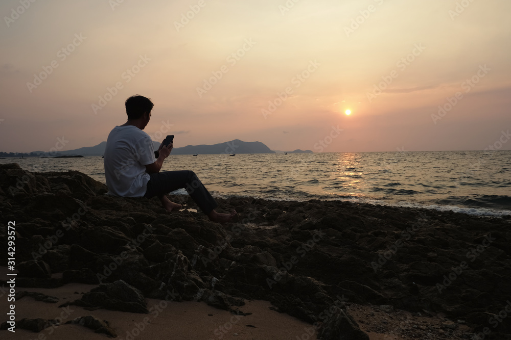 a man using mobile phone on the  beach