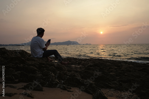 a man using mobile phone on the  beach