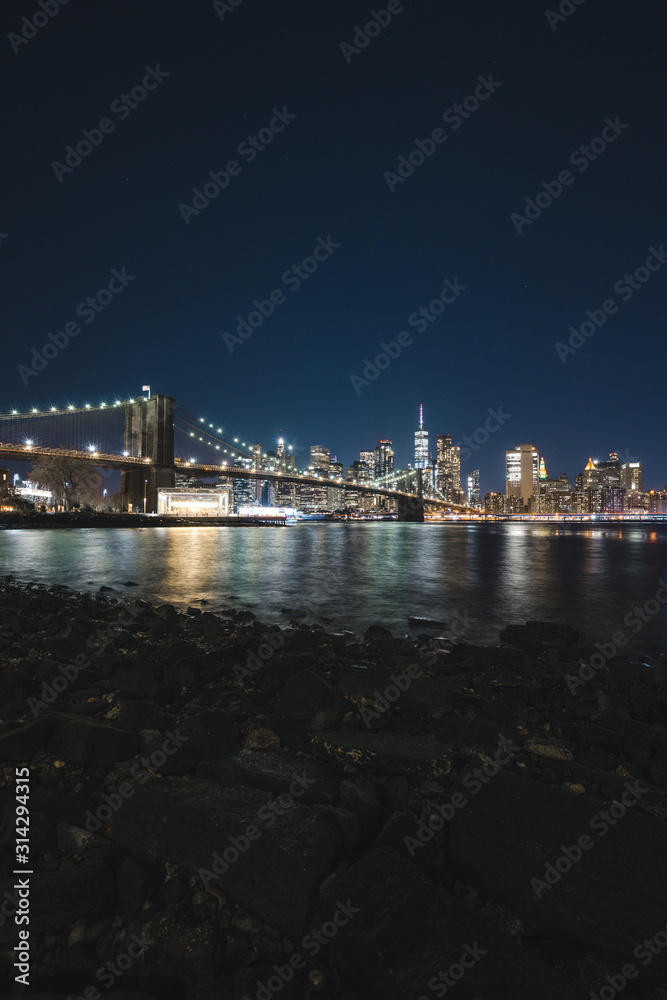 New York City Cityscape at Night taken with Long Exposure and Reflection in the River