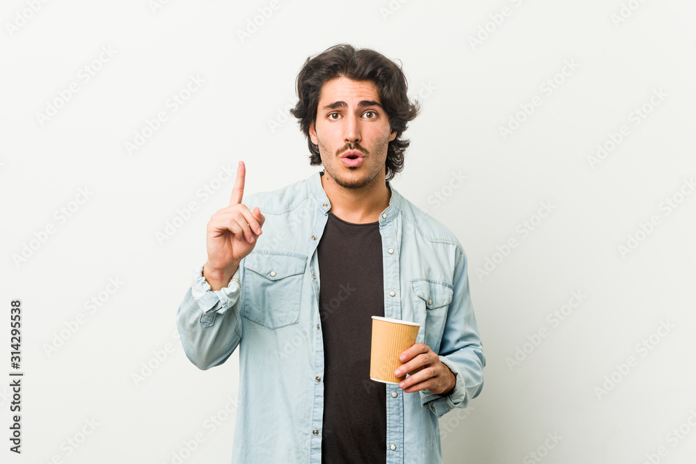 Young cool man drinking a coffee having some great idea, concept of creativity. Young cool man drinking a coffee having some great idea, concept of creativity.