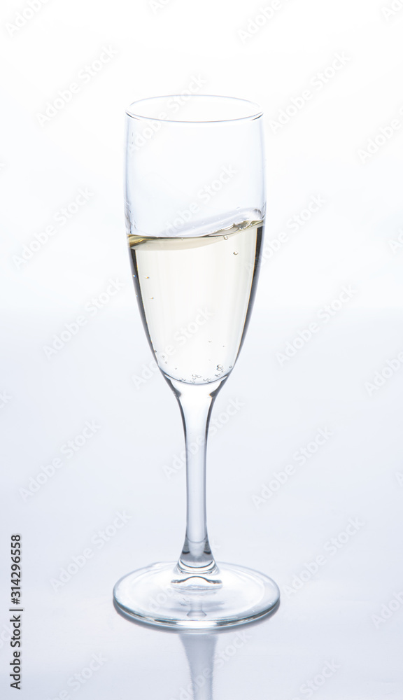 a glass of sparkling champagne is on the table. Contour light. Front view a glass of sparkling champagne is on the table. Contour light. Front view