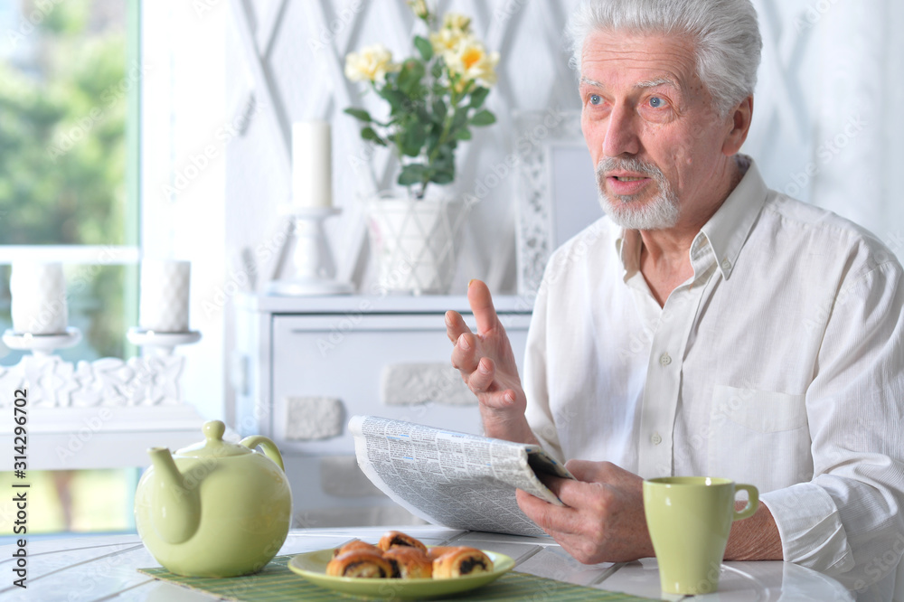 Portrait of an senior man reading newspaper Portrait of an senior man reading newspaper