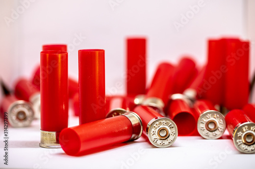 Red shotgun shell on a white background. 12 gauge. concept of hunting, defense or war. self defense.
