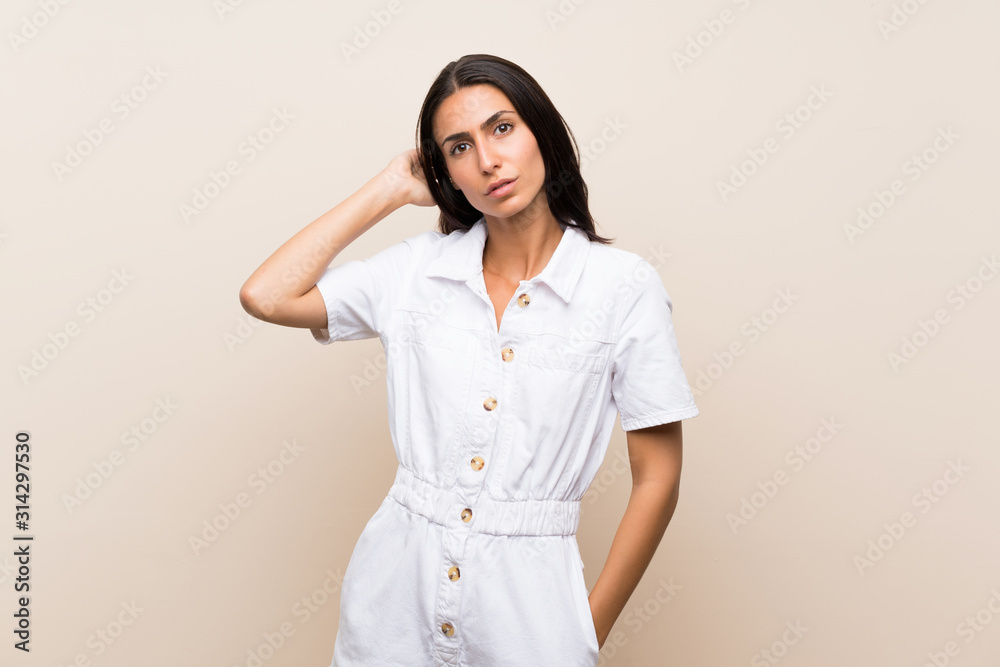 Young woman over isolated background having doubts