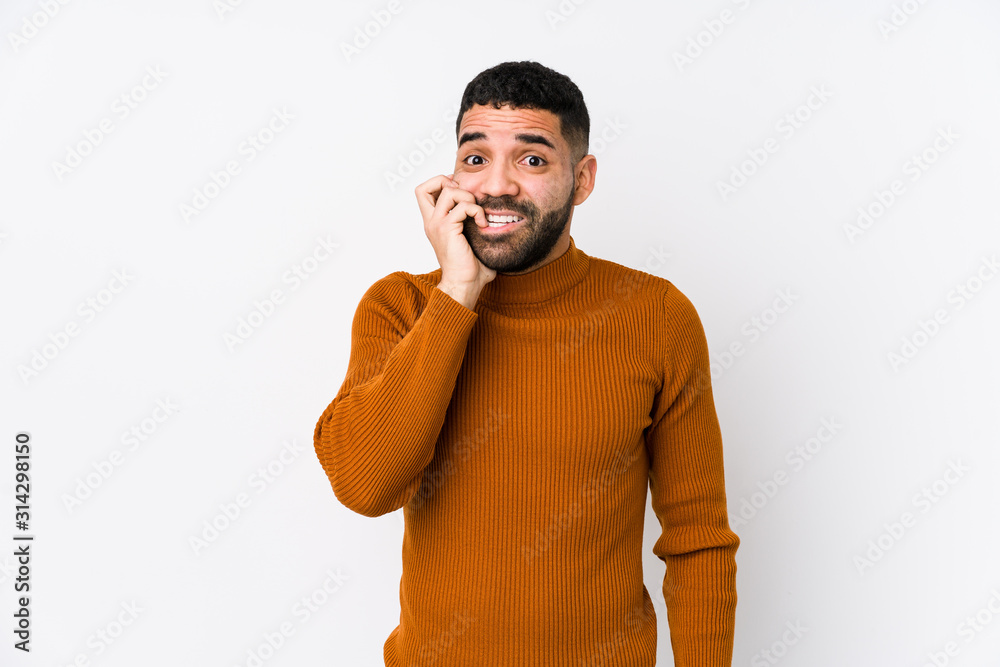 Young latin man against a white background isolated biting fingernails, nervous and very anxious. Young latin man against a white background isolated biting fingernails, nervous and very anxious.