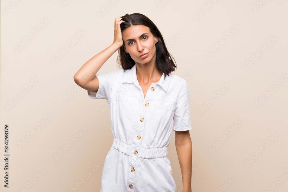 Young woman over isolated background with an expression of frustration and not understanding Young woman over isolated background with an expression of frustration and not understanding