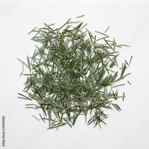 Pine needles on a white background cleaning up after Christmas holiday