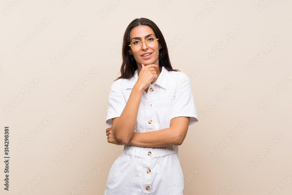 Young woman over isolated background with glasses and smiling Young woman over isolated background with glasses and smiling