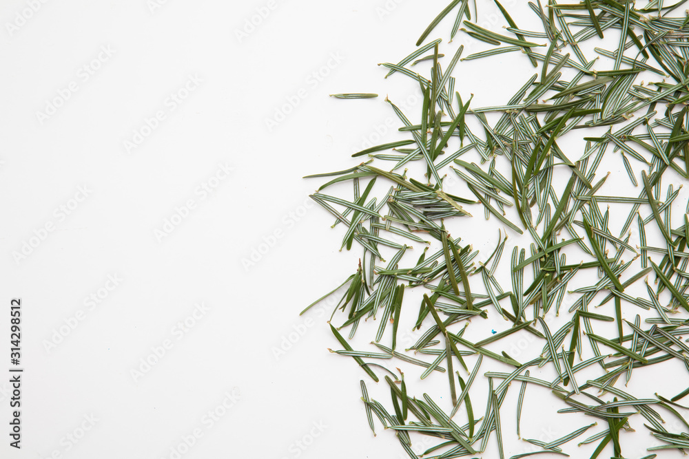 Fototapeta premium Pine needles on a white background cleaning up after Christmas holiday