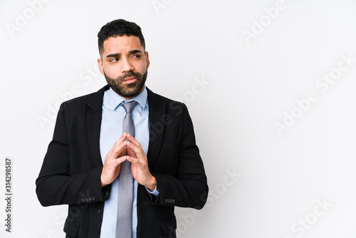 Young latin business woman against a white background isolated making up plan in mind, setting up an idea.