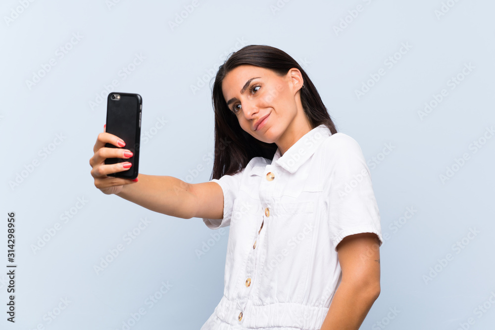 Young woman with a mobile phone making a selfie Young woman with a mobile phone making a selfie