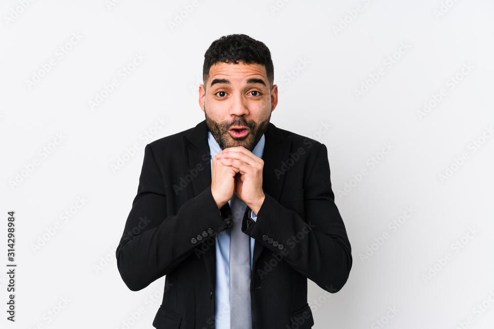 Young latin business woman against a white background isolated praying for luck, amazed and opening mouth looking to front. Young latin business woman against a white background isolated praying for luck, amazed and opening mouth looking to front.