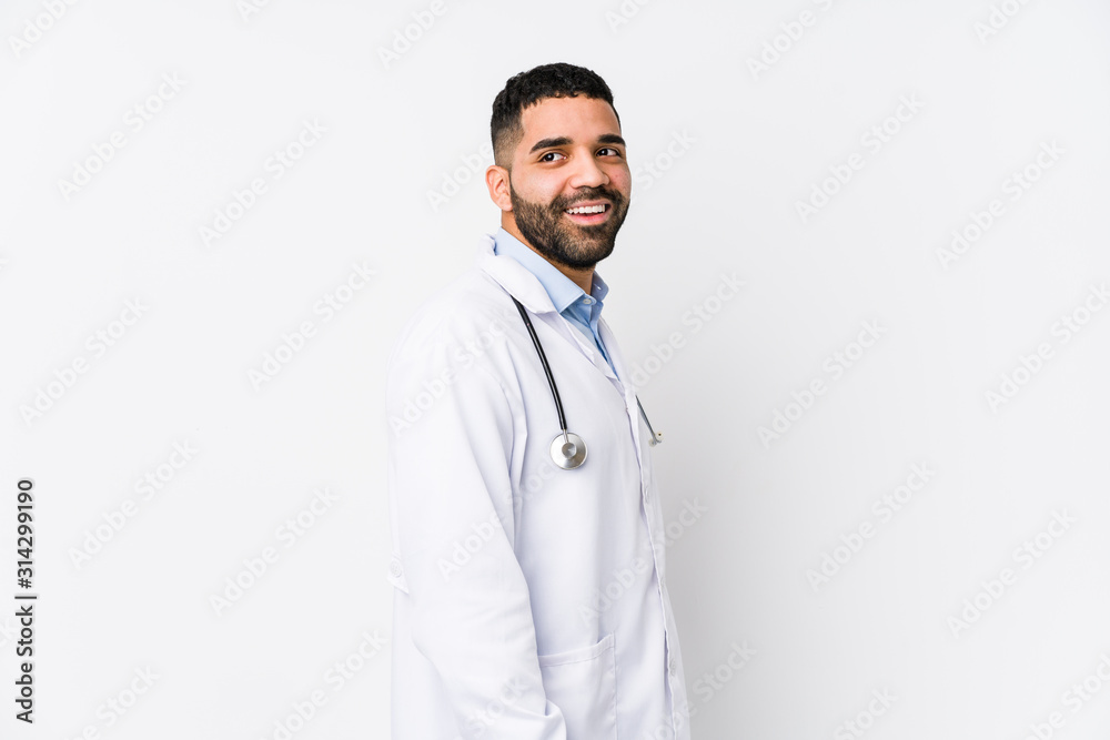 Young arabian doctor man isolated looks aside smiling, cheerful and pleasant. Young arabian doctor man isolated looks aside smiling, cheerful and pleasant.