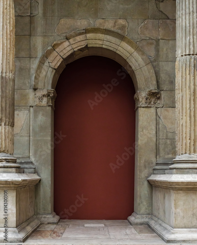 Antique door arch surrounded by columns.