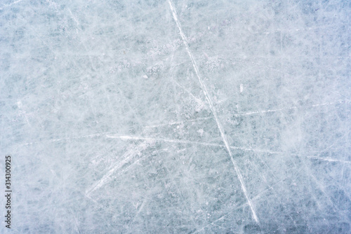 Photo Ice background with marks from skating and hockey, blue texture of rink surface