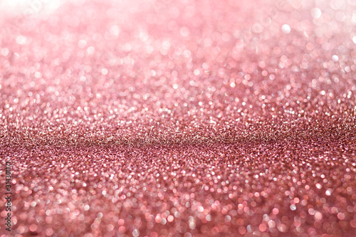 Pink glitter texture abstract background. Defocused bokeh.