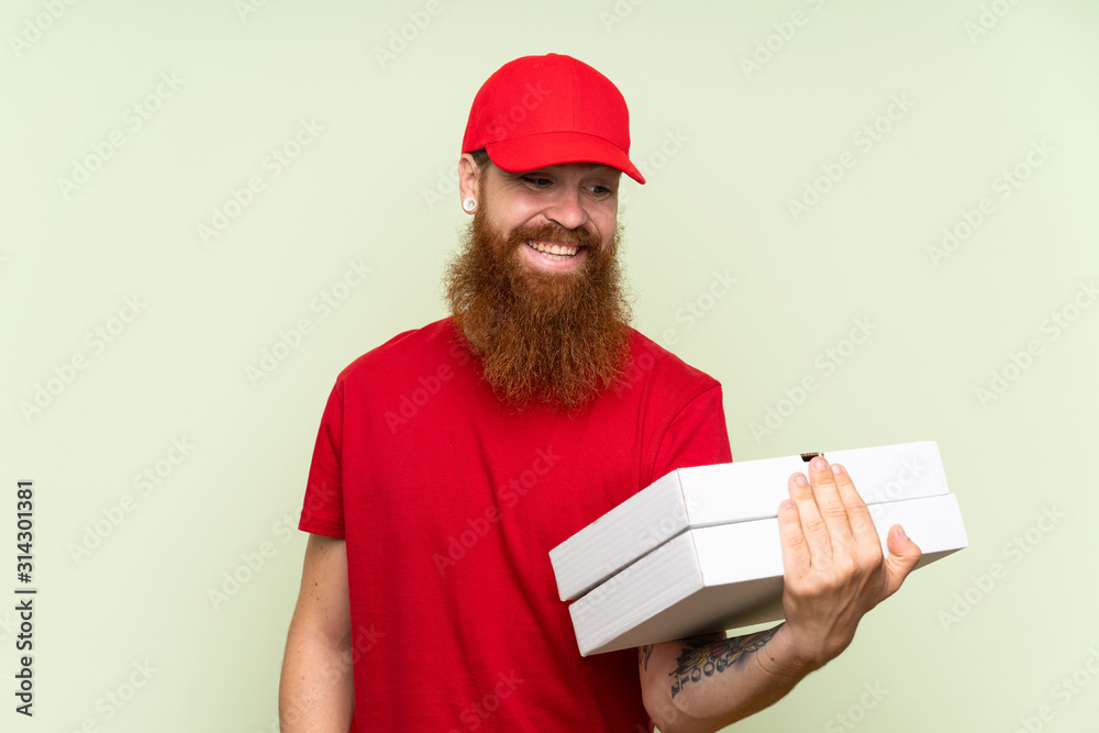 Delivery man with long beard over isolated green background with happy expression Delivery man with long beard over isolated green background with happy expression