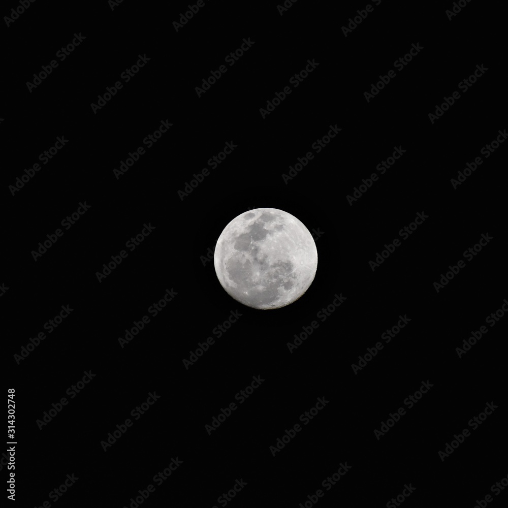 Bright white moon in dark night sky Bright white moon in dark night sky