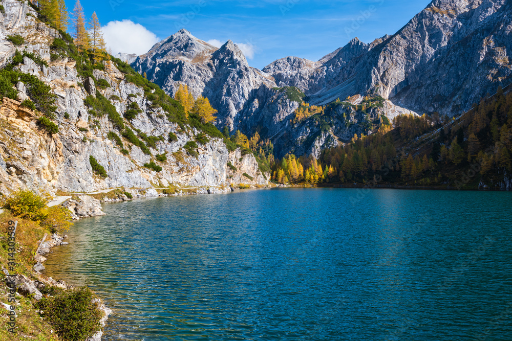 Obraz premium Sunny autumn alpine Tappenkarsee lake and rocky mountains above, Kleinarl, Land Salzburg, Austria.