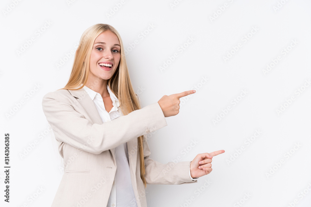 Young business blonde woman on white background excited pointing with forefingers away. Young business blonde woman on white background excited pointing with forefingers away.