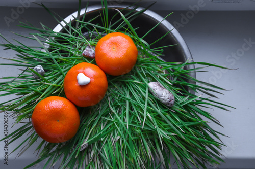 three mandarins on the green grass