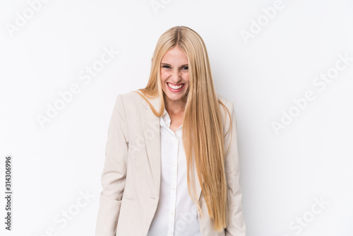 Young business blonde woman on white background laughs and closes eyes, feels relaxed and happy.