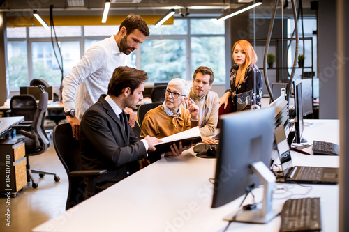 Senior businesswoman working together with young business people in modern office © BGStock72