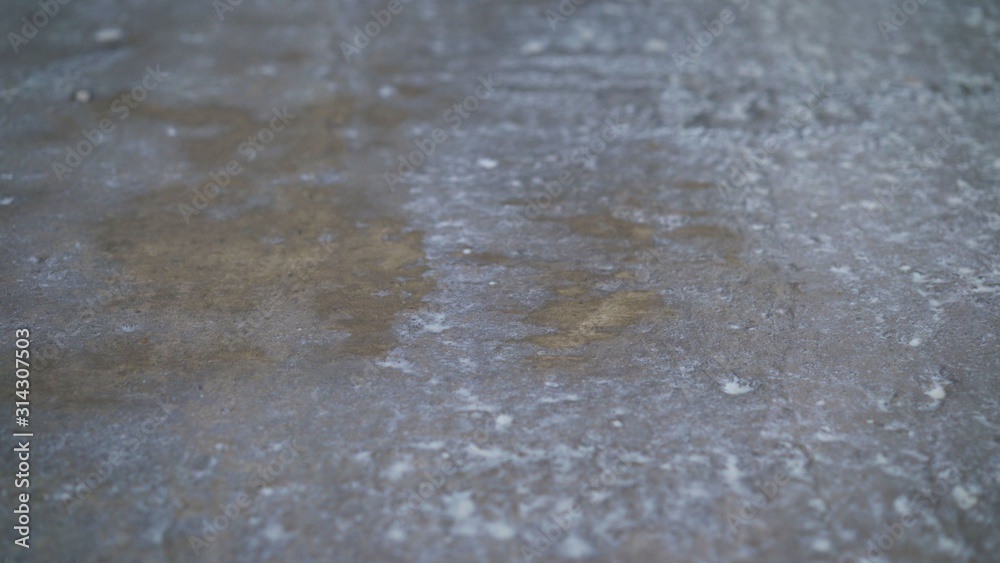 Worker puts primer with roller on concrete floor. Apartment under construction. The worker primers the concrete floor for further installation. Worker puts primer with roller on concrete floor. Apartment under construction. The worker primers the concrete floor for further installation.