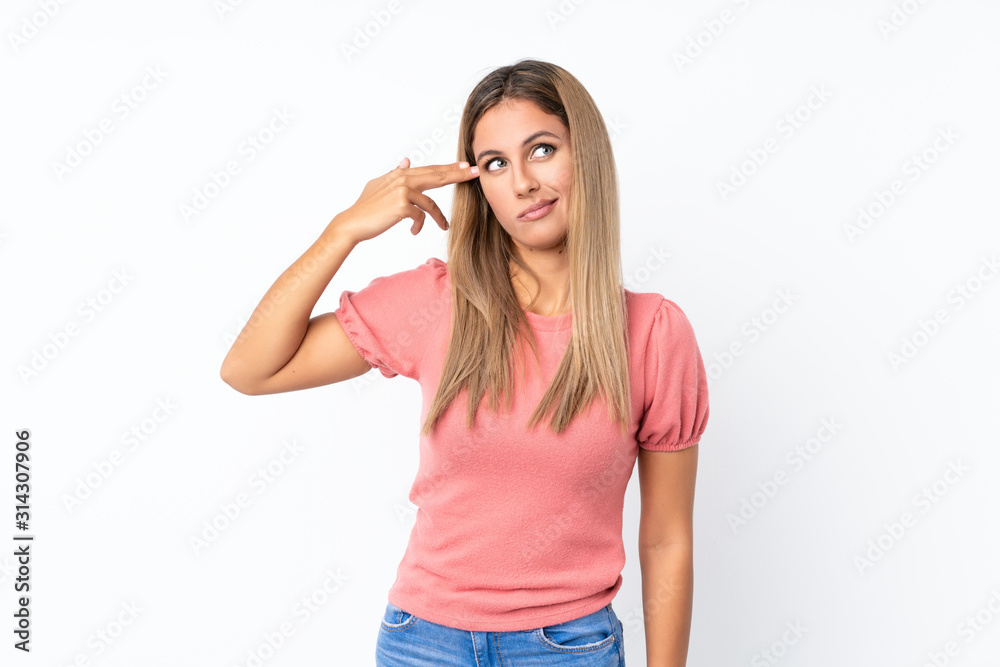 Young blonde woman over isolated white background with problems making suicide gesture Young blonde woman over isolated white background with problems making suicide gesture