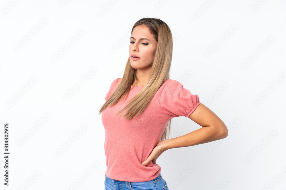 Young blonde woman over isolated white background suffering from backache for having made an effort Young blonde woman over isolated white background suffering from backache for having made an effort