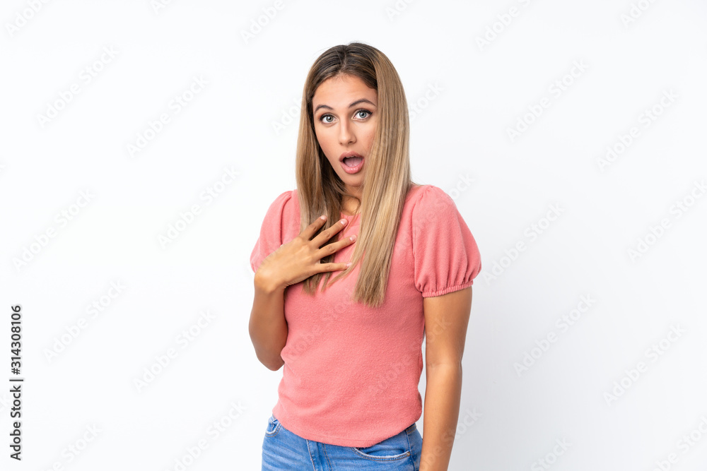 Young blonde woman over isolated white background surprised and shocked while looking right Young blonde woman over isolated white background surprised and shocked while looking right
