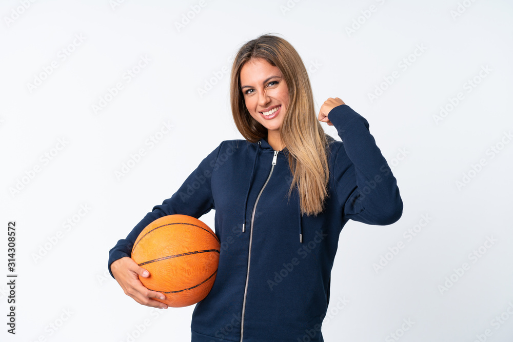 Young woman playing basketball over isolated white background Young woman playing basketball over isolated white background