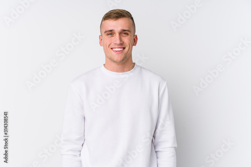 Young caucasian man on white background happy, smiling and cheerful.