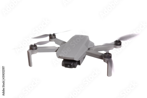 Modern quadcopter drone with a camera flying in the air. Isolated on white background.
