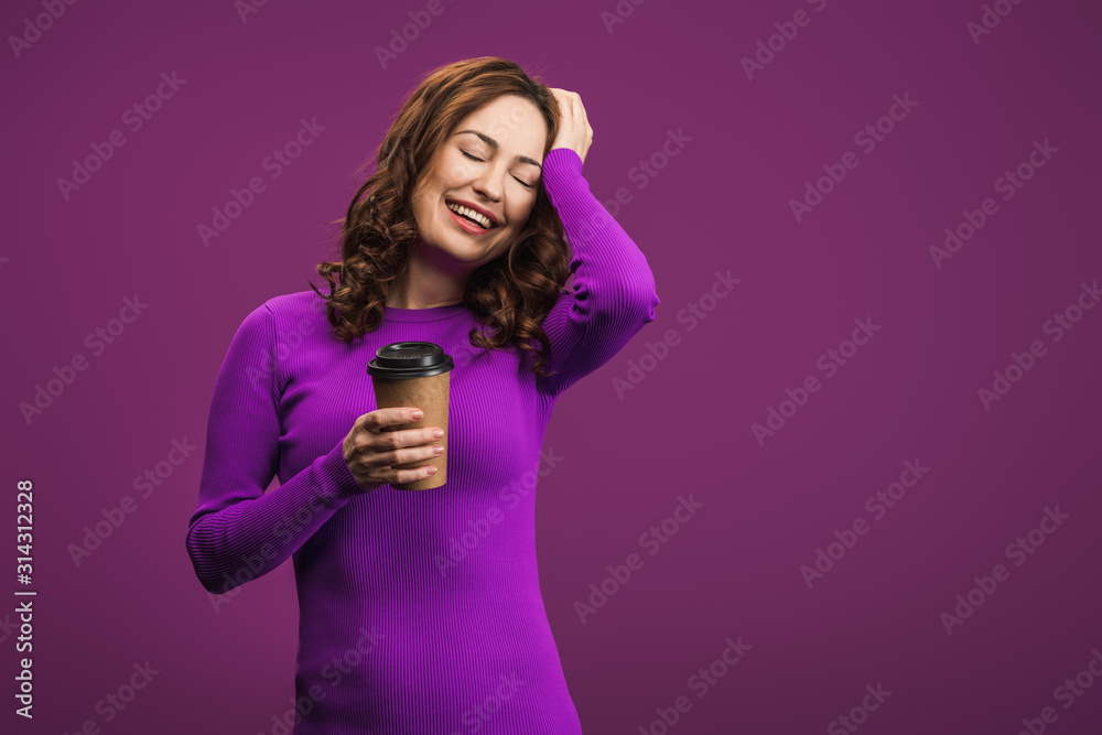 laughing girl touching head while holding coffee to go on purple background laughing girl touching head while holding coffee to go on purple background