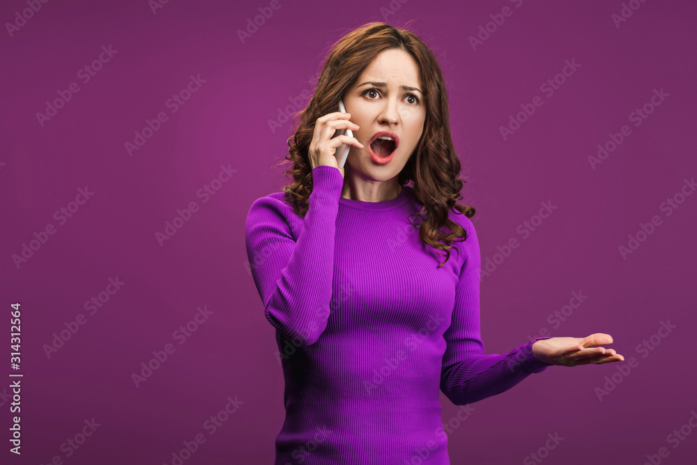 angry woman screaming while talking on smartphone on purple background angry woman screaming while talking on smartphone on purple background