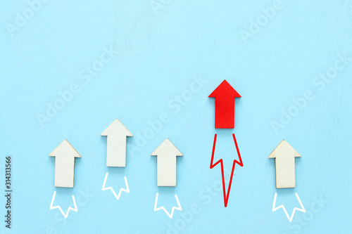 Slika na platnu Business competition concept, red arrow leading the race