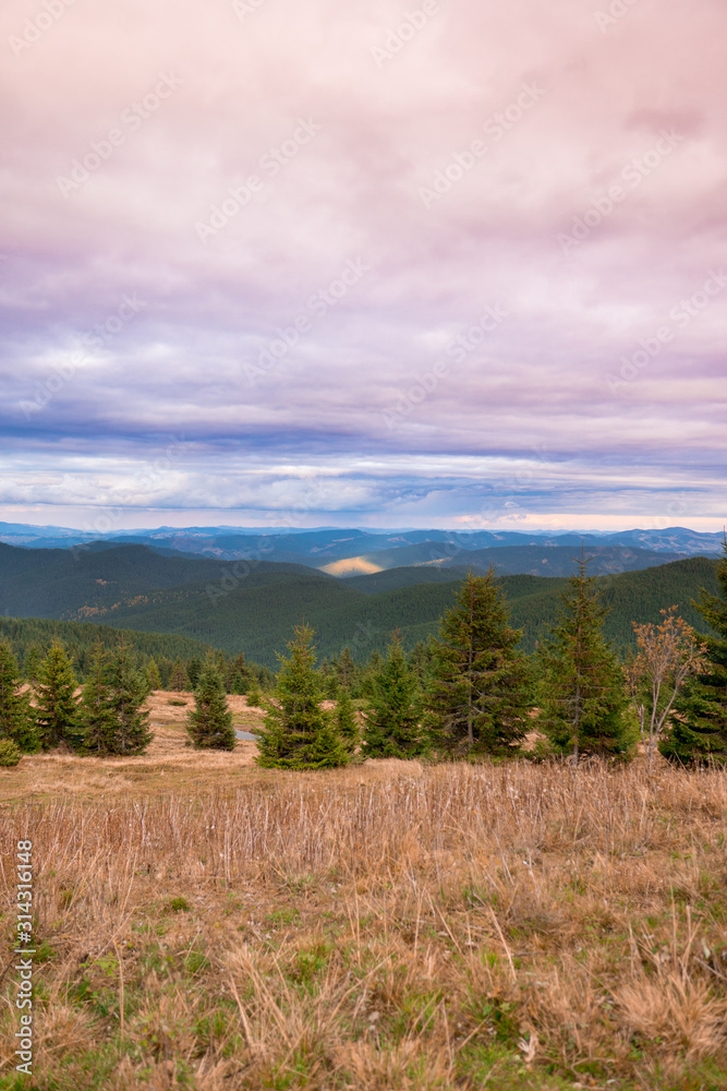 Summer landscape in mountains and the dark cloudy sky above.