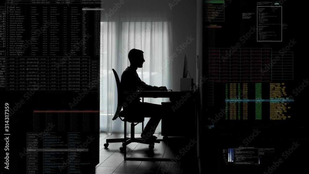 Man sits down at his desk in a dark room and starts programing / hacking / working - Digital generated overlay