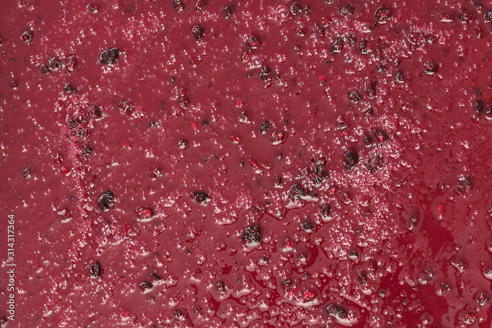 Confiture with berries. Honey with blackberries. Red color. Background, texture, close up Confiture with berries. Honey with blackberries. Red color. Background, texture, close up