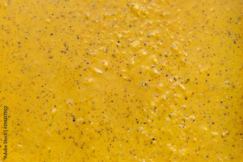 Cream honey. Honey with pollen. Body scrub, yellow color. Background, texture, close up.